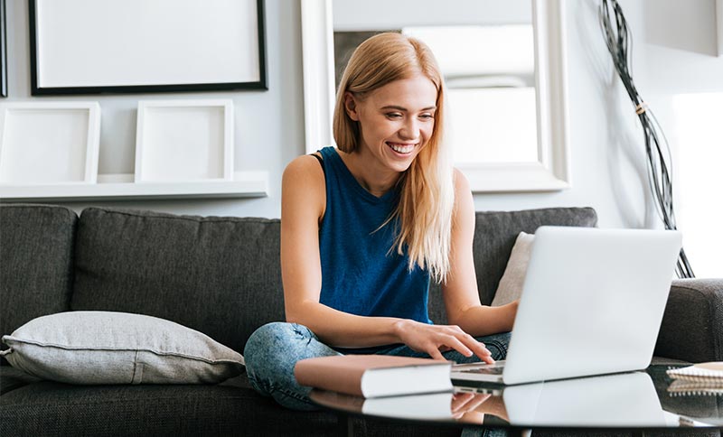 happy-woman-customer-using-laptop-home