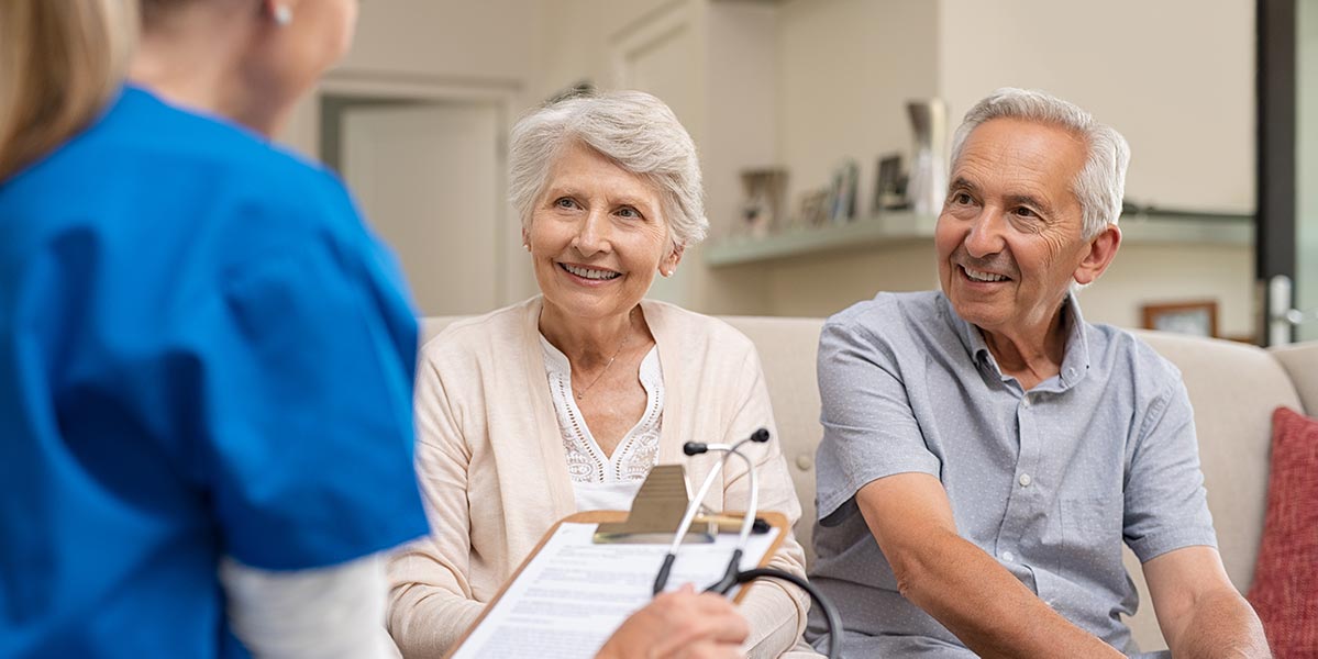 Nurse consulting with senior residents in a nursing home